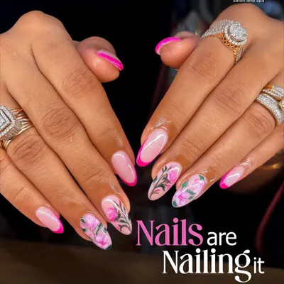 When your nails are this good, you can't help but feel confident. This look features a chic French manicure with a hot pink twist and delicate floral art on an accent nail, creating a fun yet sophisticated style.