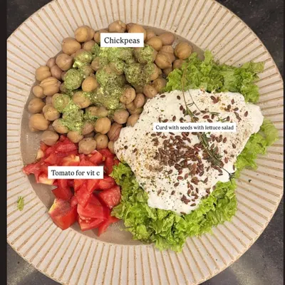 A perfectly balanced plate. This client meal features chickpeas for protein, fresh tomatoes for vitamin C, and curd with seeds over lettuce for probiotics and healthy fats. This is how we nourish the body.
