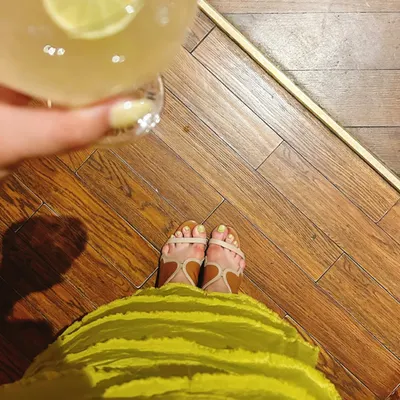 I love a good color theme. This shot is a fun way of showing my personal style, coordinating my chartreuse dress with my cocktail and nails. It’s all in the details.