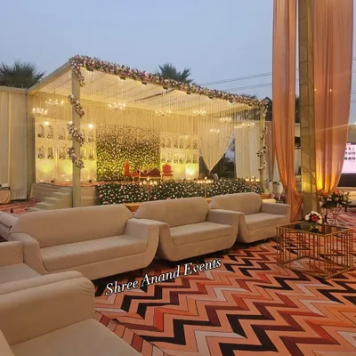 A side view of the elegant floral stage, showing the comfortable lounge seating arranged for guests to have a perfect view of the proceedings.