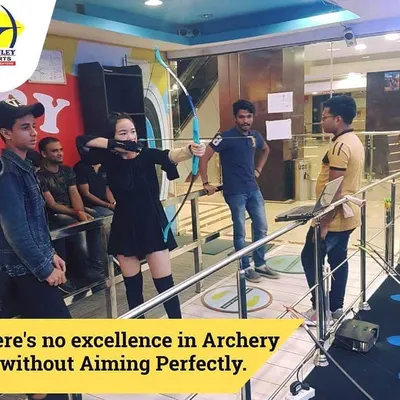 A customer takes her stance, demonstrating perfect aiming form. Our instructors help you learn the correct technique for a better shot.