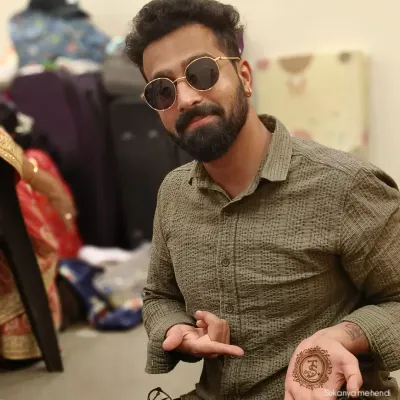 Mehendi isn't just for brides. I create stylish and simple designs for grooms too, like this personalized initial in a mandala, so they can be a part of the tradition in their own way.