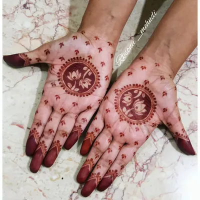This is the beautiful, deep red stain that my herbal henna produces. The design, featuring a lotus and swans, looks even more stunning with this rich color. No filters needed, just the magic of pure henna.