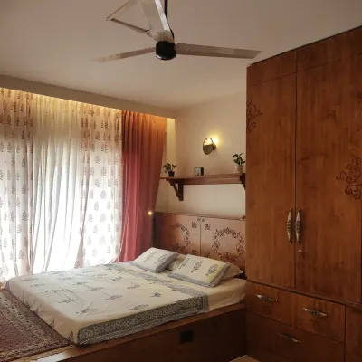 A full view of the master bedroom from #TheSampadaHome, showing how the custom platform bed, carved headboard, and matching wardrobe create a cohesive and elegant wooden interior.