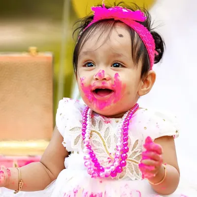 The pure joy of a first birthday cake smash! This close-up captures the delightful mess and happy expression that makes these sessions so memorable.