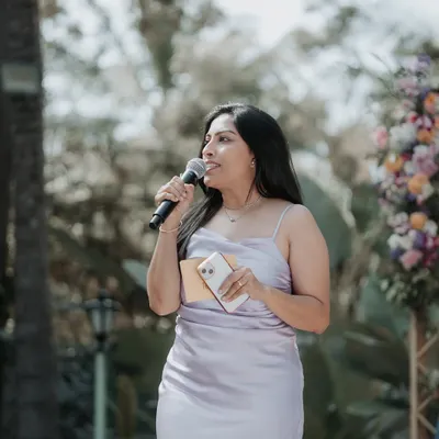 A candid shot of me speaking at an outdoor wedding. Even when not posing for the camera, my focus is always on the audience and the flow of the event.