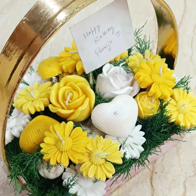 This candle bouquet basket is a unique and fragrant alternative to traditional flower arrangements. Filled with an assortment of yellow and white flower-shaped candles, it makes for a stunning and lasting gift for birthdays or thank yous.