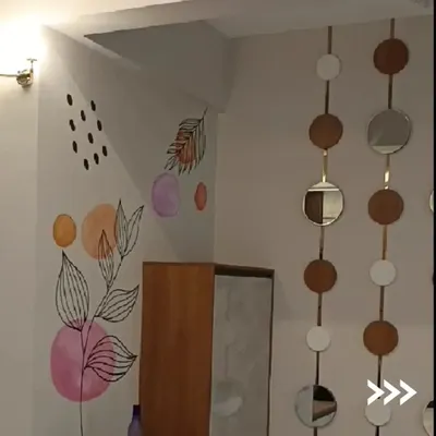 This is a custom mural we painted in the corner of a room, featuring abstract and line-art botanicals. This type of artistic finish turns a plain wall into a personal statement and a central feature of the room's decor.