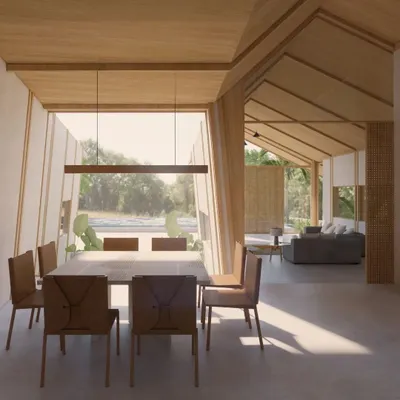 A render of the dining and living area in our upcoming Cumin Residence in Goa. The design features a pitched wooden ceiling and a large window framing the outdoors, creating an open, airy space that is deeply connected to nature.