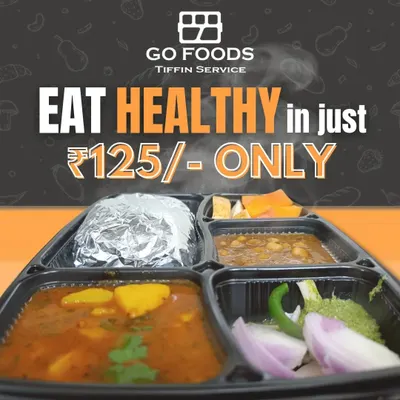 A glimpse of our standard daily vegetarian tiffin. This particular meal features an aloo matar sabzi, chana dal, foil-wrapped rotis to keep them soft, and a side of fresh onion and chili salad.