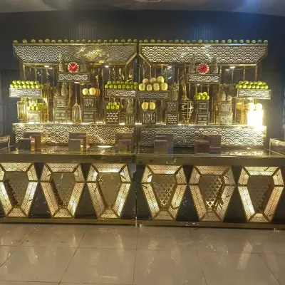 An example of our elaborate and stylish buffet counters. This stunning golden setup is not just for serving food but also acts as a decorative centerpiece for the dining area, complete with fruit displays.