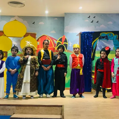 The full cast of our Aladdin musical takes a bow. My theatre workshops culminate in a final performance, giving children the thrilling experience of being on stage.