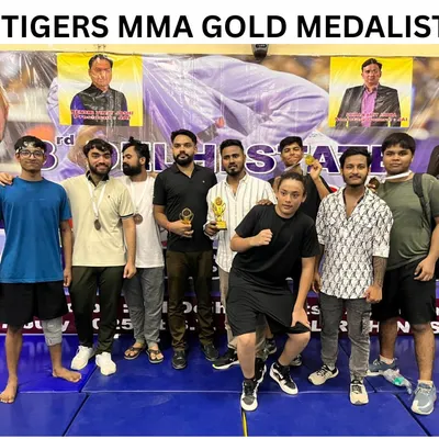 The team celebrating after a successful tournament. These medals and trophies are proof of our dedication. We are the Tigers MMA gold medalists.