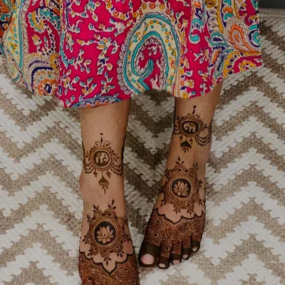 A stunning bridal feet design featuring elephant and lotus motifs. The details are focused on the top of the feet, leaving the sides open for a balanced look.