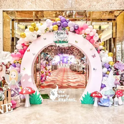 A grand entrance to an enchanted fairyland. This circular arch, adorned with pastel balloons and flowers, framed a magical pathway leading guests into Aarṇa's first birthday celebration.