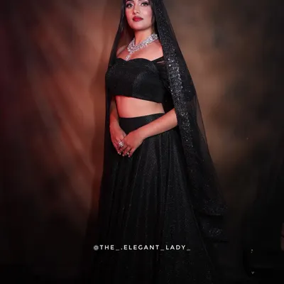 A dramatic and glamorous look featuring a stunning multi-layered CZ necklace set. Paired with a black lehenga and a sparkling dupatta, this is the perfect statement for a reception.