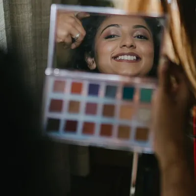 A candid moment of the bride seeing her makeup in the mirror. That happy smile is what it's all about.
