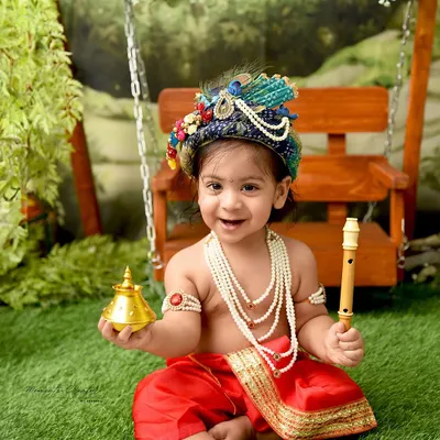 The most charming little Krishna with a mischievous smile. Holding a golden bell and his flute, this little one perfectly embodies the playful spirit of Kanha.