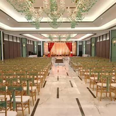 A complete transformation of a banquet hall for a wedding ceremony. We designed the stage with a red and gold backdrop, arranged elegant guest seating, and installed beautiful hanging floral chandeliers from the ceiling.