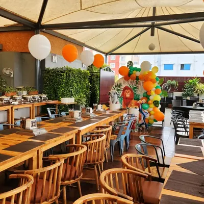 An example of a setup inside a restaurant venue. I can bring my decor, like this jungle-themed balloon arrangement, to complement the existing space for a birthday party or other event.