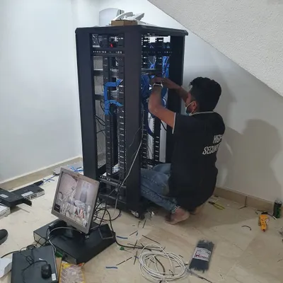 Here I am organizing network cables inside a server rack. Proper security system cable management is crucial for preventing connection issues and making future maintenance simple.