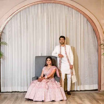 A portrait that feels both regal and relaxed. The elegant archway and soft lighting create a sophisticated frame, while their pose shows a quiet confidence. This style is perfect for capturing the grace of your relationship.