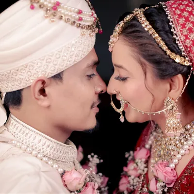 An intimate close-up of the bride and groom, nose to nose, capturing a moment of pure connection and love.