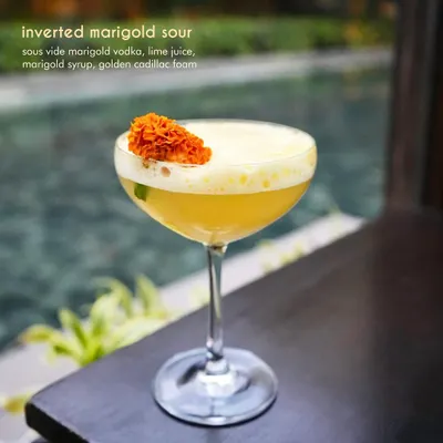 Our Inverted Marigold Sour is a celebration of floral flavors. We use sous vide marigold vodka, fresh lime juice, and a delicate marigold syrup, topped with golden cadillac foam. The result is a bright, aromatic, and visually stunning cocktail.