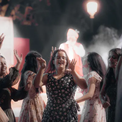 A young woman in the audience dances with a huge smile, completely lost in the moment. These are the candid shots that truly capture the spirit of a live event.