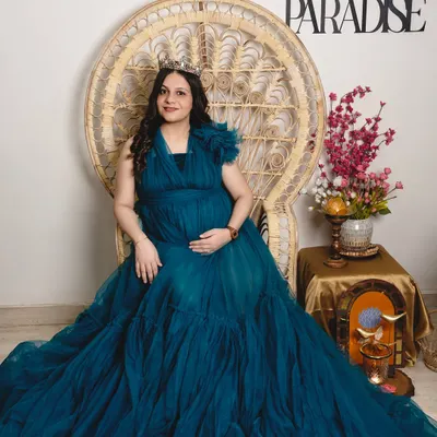 Seated like a queen on a throne, because that's what every mother is. This portrait is designed to be regal and powerful, celebrating the mom-to-be in all her glory.