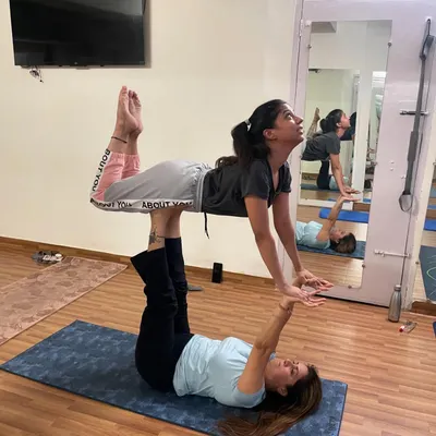 A classic 'flyer' pose that is fundamental to acroyoga. I teach the base how to create a stable foundation and the flyer how to use their body weight and core to float effortlessly. This pose is a key milestone for building confidence.