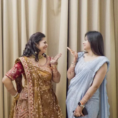 Capturing the fun and candid interactions between the bride and her friends or family during the wedding festivities.