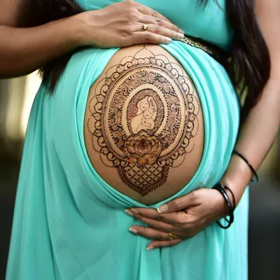 A special blessing for the mom to be. This pregnancy belly henna features a mother and child silhouette inside an intricate mandala frame, created with my all natural, organic paste that is completely safe for you and your baby.