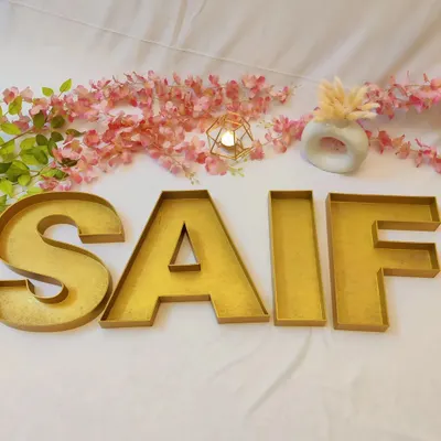 I love creating things that are both beautiful and useful. These large monogram letter trays, spelling out the name 'SAIF', are perfect for stylishly packing wedding favours or dry fruits for your guests.
