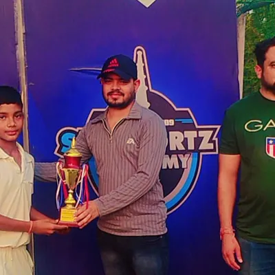 A proud moment as a young cricketer receives a trophy for his outstanding performance, recognized by our academy coaches.