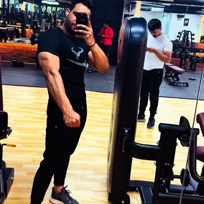 A classic post-workout mirror selfie. This member is celebrating a solid session and the visible results of his dedication to building muscle and strength.