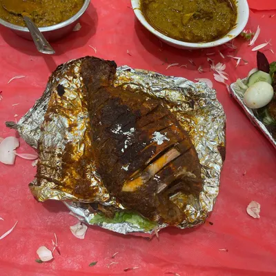 A whole grilled fish, served on foil to keep it hot and juicy. This is a popular choice for groom's tables and special family dinners.