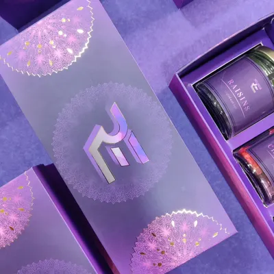 An example of our premium custom packaging capabilities. This purple gift box for a corporate client features their logo in a stunning holographic foil finish, complemented by intricate silver mandala patterns for a truly luxurious feel.