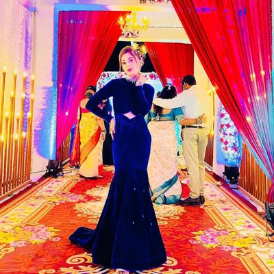A client looking absolutely stunning in a royal blue velvet mermaid gown I designed for a wedding reception. The dramatic silhouette and rich fabric make it a real head-turner.