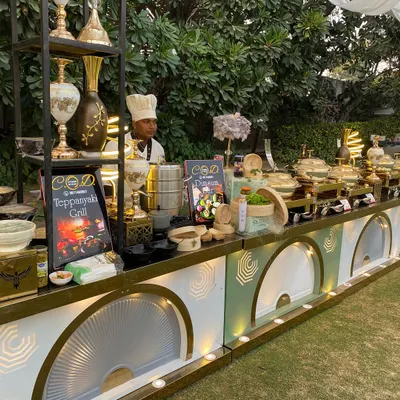 A full view of our Teppanyaki and Dimsum grill station at an outdoor event. The setup is designed for interaction, with uniformed chefs ready to cook fresh for your guests on this elegant, illuminated counter.