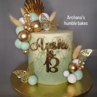 A stylish and modern cake for a 13th birthday. The mint green and gold color scheme is perfect for a teenager's celebration.