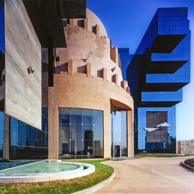 The Unit Trust of India HQ, the first building in Mumbai's BKC district, was designed to project stability and a futuristic outlook. Its form is an amalgamation of historical influences and contemporary adaptations, creating a timeless architectural statement.