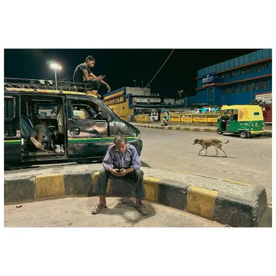 00:07am: Cab drivers wait for passengers at a deserted railway station during a city lockdown. This image set the stage for a project documenting a city in a unique state of quiet.