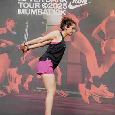 Leading a yoga session for the Nike After Dark Run Tour in Mumbai. It's always powerful to guide a large group, sharing the importance of stretching and mobility for runners.