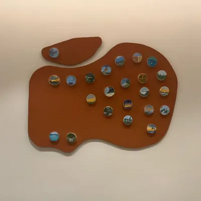 This is the "Our Memories" piece, a custom travel story canvas created for a family of avid travelers. The apple-shaped board serves as a unique backdrop for over twenty miniature paintings of their favorite destinations.