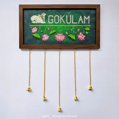 I love creating custom nameplates that reflect a family's personality. This "Gokulam" nameplate features a Pichwai-style cow and lotus details on a rich green background, complete with little hanging bells for a charming touch.