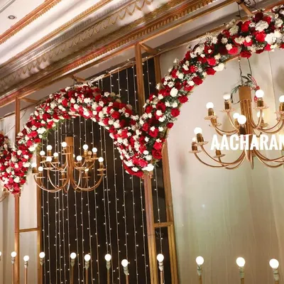 Here’s a closer look at the details that make a stage special. This shot highlights the dense, hand-arranged floral arches and elegant chandeliers from one of our premium indoor setups, showing the quality of our event production work.