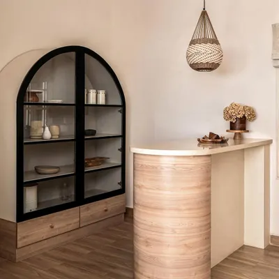 A statement bar I designed for a client who loves to host. The curved oak base, marble top, and arched display cabinet create a sophisticated and welcoming entertainment hub.