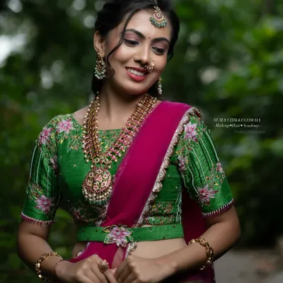 This look, created for an Airbrush Masterclass, features a vibrant green and pink lehenga. The makeup is fresh and dewy, with a focus on glowing skin and bright eyes, perfect for a festive occasion.