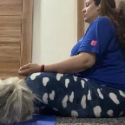 A client peacefully meditating during her prenatal yoga practice. These sessions focus on gentle movements and breathing to reduce stress and connect with her changing body.